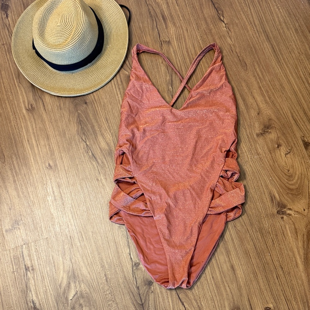 Women’s One Piece Swimsuit in Rust Orange. Side cut outs. Brand: Soluna